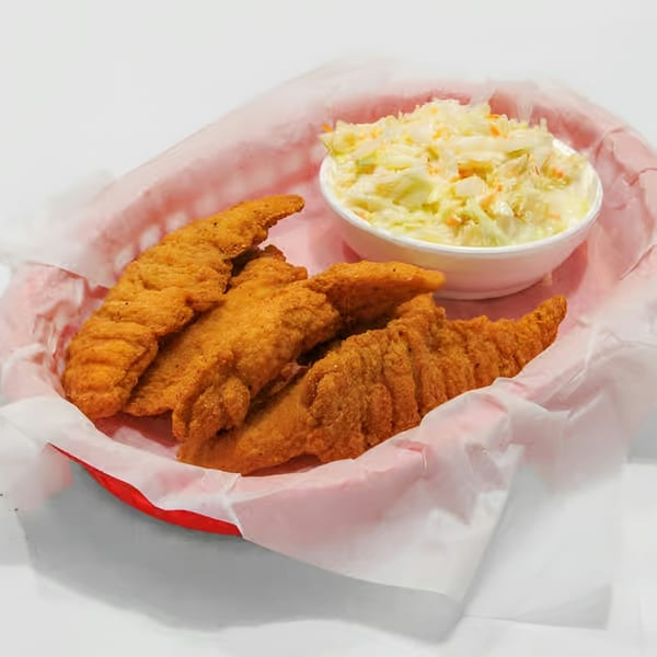 Fried fish fillets and a side of coleslaw in a red basket lined with white paper.